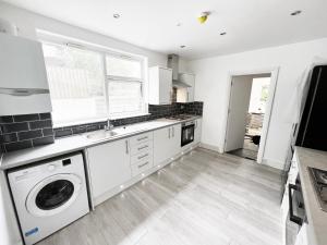 a kitchen with a washer and dryer at Minet Gardens - Centrally located Apartment - Rm 1 in London