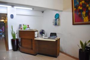 a restaurant with a counter with a phone on it at The Boni Tower by RSPL Manila City Center in Manila