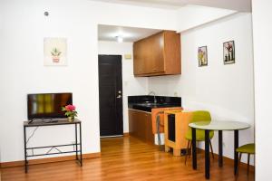 a small kitchen with a table and a small table and a table at The Boni Tower by RSPL Manila City Center in Manila
