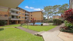 an apartment complex with a pool in a yard at Berdella Park 9 in Port Macquarie
