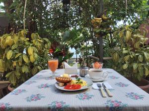 a table with a plate of food on it at Hostal Kurmi - Coroico in Coroico