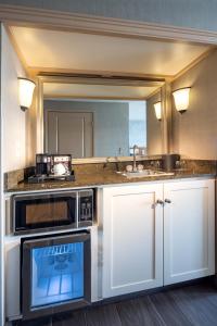 a kitchen with a microwave and a sink at Silver Cloud Hotel Tacoma Waterfront in Tacoma