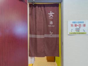 a door with a curtain in a room at Tabist Business Ryokan Akashiya Annex in Akashi