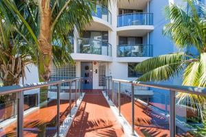 - Balcón con vistas a un edificio con palmeras en Flightdeck 203 5-7 Clarence Street PM, en Port Macquarie