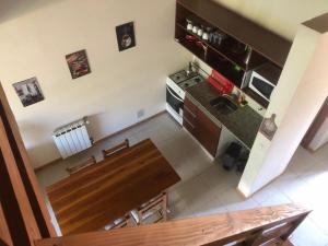 an overhead view of a kitchen with a wooden table at Villa Catedral in San Carlos de Bariloche
