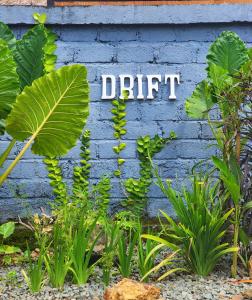 a blue wall with the word dirt written on it at Drift Hideaway in Kuta Lombok
