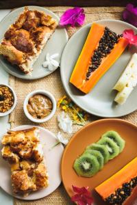 a table topped with plates of food and desserts at Pousada Pouso da Maré in Ilha de Boipeba