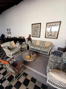 a living room with several couches and chairs at Casa Yoly Hostel Granada in Granada