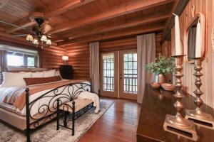 a bedroom with a bed in a room with wooden walls at Rustic Cabin with seasonal Pool & Fire Pit - close to to Bike Path in Celina