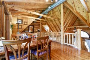 a dining room with a wooden table and chairs at Rustic Cabin with seasonal Pool & Fire Pit - close to to Bike Path in Celina