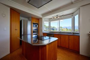 a kitchen with a counter and a large window at Views on Scarborough in Kaikoura