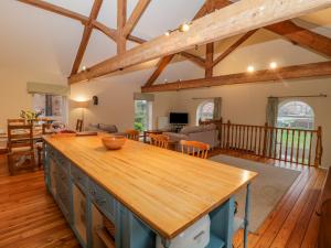 a kitchen and living room with wooden beams at The Old Chapel in Bishop Wilton