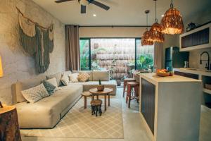 a living room with a couch and a table at Vida Boho Apart 3 with special fee to access Hotel Bardo in Tulum