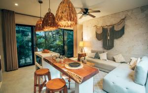 a living room with a table and a couch at Vida Boho Apart 3 with special fee to access Hotel Bardo in Tulum