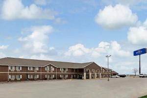 a large brick building with a parking lot at Baymont by Wyndham Omaha SW in Omaha