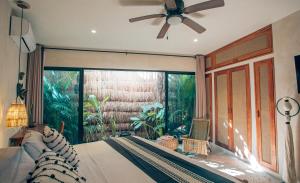 a bedroom with a bed and a ceiling fan at Vida Boho Apart 3 with special fee to access Hotel Bardo in Tulum +29 photos