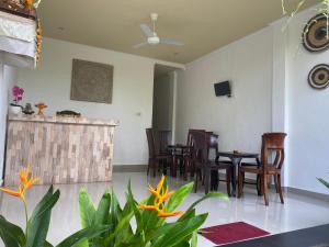 a living room with chairs and a table at Pulu Sari Suite Ubud in Ubud