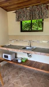 a kitchen with a sink and a window at Apartamento Entero El Guanacaste. in Santa Cruz