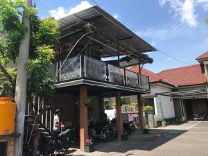 a house with a balcony on top of it at Harys homestay in Triwung