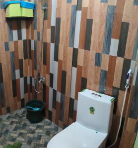 a bathroom with a toilet and a shower at Blue Lagoon Inn in Pagudpud