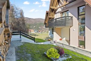 a view from the backyard of a house with a balcony at Pensiunea Podul Simonului in Bran