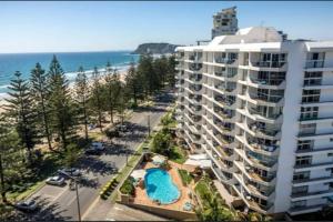 an aerial view of a large apartment building and the beach at Solnamara - Hosted by Burleigh Letting in Gold Coast