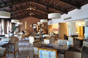 a restaurant with tables and chairs and people in the background at Museum Resort Spa in Bodrum City