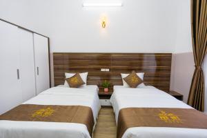 Postel nebo postele na pokoji v ubytování PHÚ QUÝ HOTEL near ĐÔNG KINH MARKET