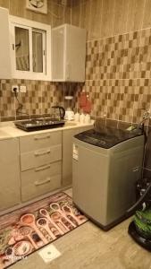 a kitchen with a stove and a counter top at anoor appartment,just relaxe in Obhor