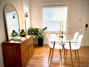 a dining room with a table and chairs and a mirror at LBC Paradise Bungalow in Long Beach