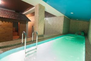 a bathroom with a large tub in a room at Hotel Prietenia in Bender