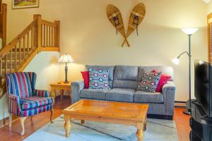 a living room with a couch and a coffee table at SaltBox 1B in White River Junction