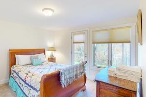 a bedroom with a bed and a window at SaltBox 1B in White River Junction