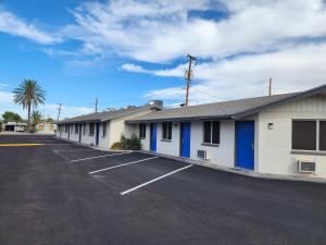 a row of buildings in a parking lot at Chandler Inn in Chandler