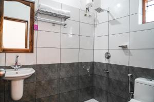 a bathroom with a shower and a sink at Aloha Homestay in Varkala