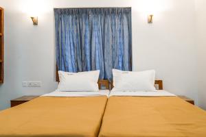 Ένα ή περισσότερα κρεβάτια σε δωμάτιο στο Aloha Homestay