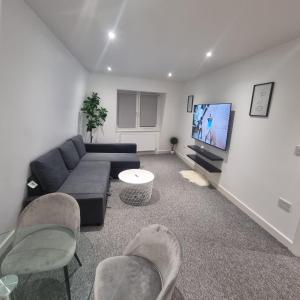 a living room with a couch and a tv at 2 bed apartment in Plumstead London in Plumstead