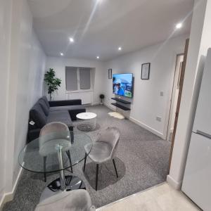 a living room with a couch and a tv at 2 bed apartment in Plumstead London in Plumstead