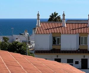a view of a building with red tile roofs at Olhos do mar 209 grande terraço vista mar in Olhos de Água