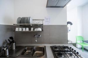 een keuken met een wastafel en een fornuis bij Hostel 94 in Sliema