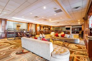 a hotel lobby with couches and chairs in a room at Wyndham Omaha Hotel - West Dodge in Omaha