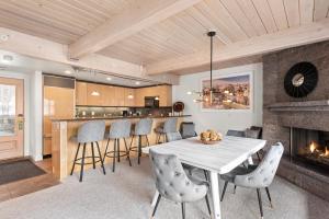 a kitchen and dining room with a table and a fireplace at Standard Two Bedroom - Aspen Alps #402 in Aspen