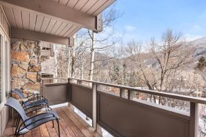 a balcony with chairs and a view of the mountains at Standard Two Bedroom - Aspen Alps #402 in Aspen