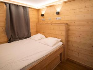 a bed in a wooden cabin with a window at Appartement moderne à Val Thorens - 4 pers - 1 chambre, 1 cabine, skis aux pieds, balcon - FR-1-637-30 in Val Thorens