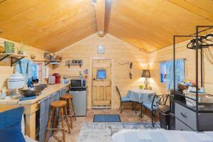 a kitchen and dining room of a tiny house at Studio Log Cabin With Aurora Views in Fairbanks