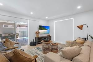 a living room with a couch and a fireplace at Ilanga Jervis Bay-Heated Pool in Huskisson