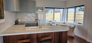a kitchen with a sink and a counter top at Stanley Village Waterfront Accommodation in Stanley