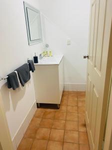 a bathroom with a sink and a mirror at Buccaneer Motel in The Entrance +39 photos