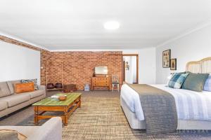 a bedroom with a bed and a living room at Little Haven, Jervis Bay in Falls Creek