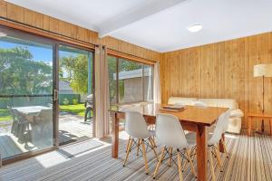 a dining room with a table and chairs at Berry by The Bay in Vincentia
